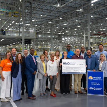 Group of people holding a large check