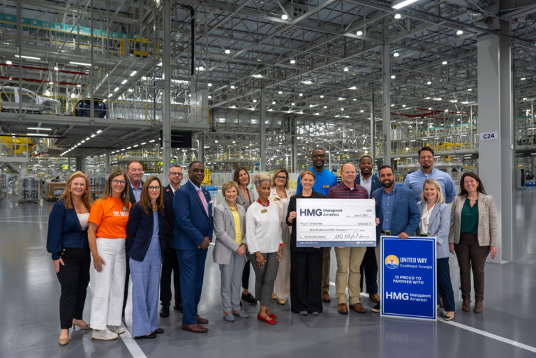 Group of people holding a large check